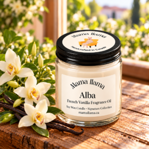 Alba French vanilla soy wax candle with closed black lid beside creamy orchids and vanilla pods